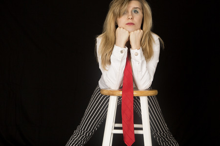 Female portrait leaning on elbows and barstoolの写真素材