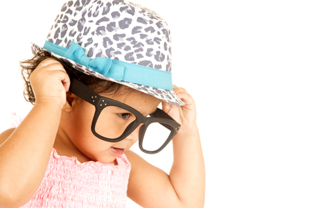 Hispanic toddler girl playing with big glassesの写真素材