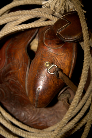 Old American western cowboy saddle and ropeの写真素材