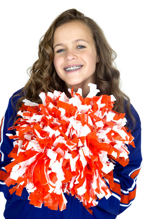 teen cheerleader with pom poms smiling braces