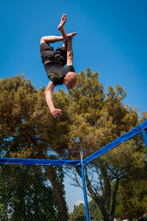 A man jumping and doing tricks on a tranpoline or canvas 