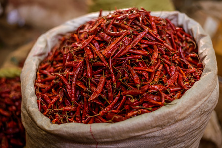 Red chilli peppers in a bag on marketの写真素材