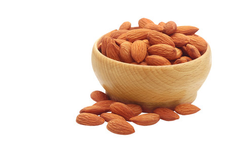 Almond in wooden bowl isolated on white background with clipping path.の写真素材