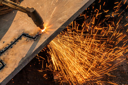 Welding work in the construction site with sparks and smoke.の写真素材