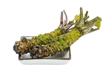 Horseradish roots in a bowl isolated on a white backgroundの写真素材