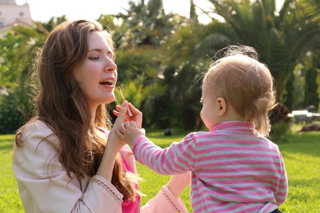 Clouse-up portrait. Mother and her little daughter making up. horizontalの写真素材