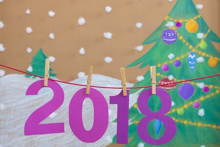 2018 new year. against the background of a painted Christmas tree and snowの写真素材