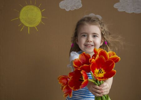 March 8 - International Womens Day. Young blond woman with bouquet of bright spring tulipsの写真素材