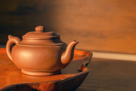 Retro clay Chinese teapot on a brownの写真素材