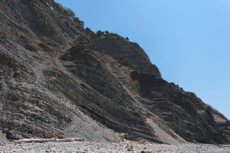 A rock wall against a blue sky. beautiful rocky outdoor mountainの写真素材