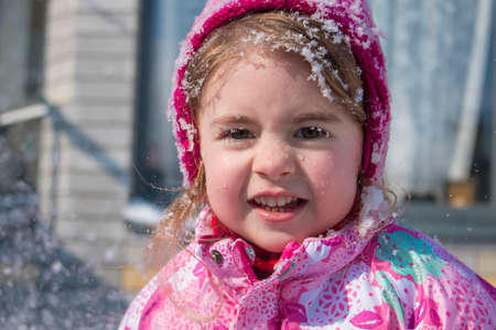Close up Portrait of cute little girl in winterの写真素材