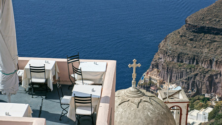 View of Santorini Island, Greece. Rooftop, restaurant, church and cross.の写真素材