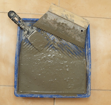 Construction works - of tools for laying ceramic tileの写真素材