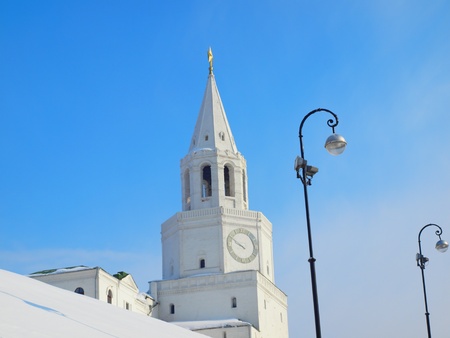White clock tower and the street light against the blue sky.の写真素材