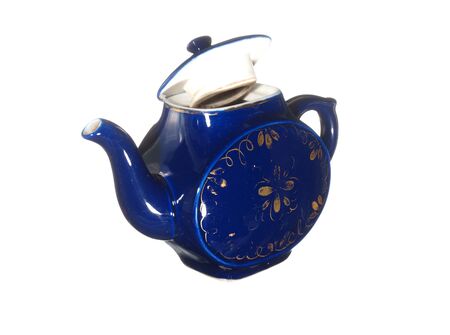 Old ceramic teapot blue with gold pattern isolated on white background.の写真素材