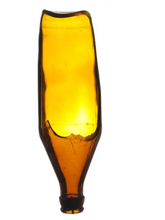 Old broken glass beer bottle of brown color isolated on a white background.の写真素材