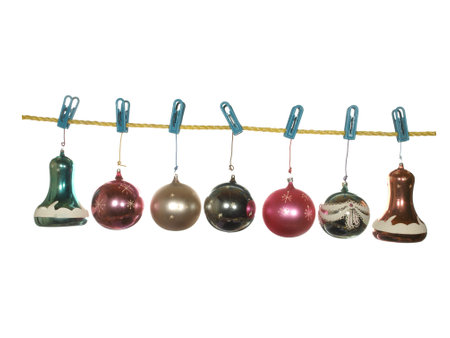Festive glass balls on a cord of gold color isolated on a white background.