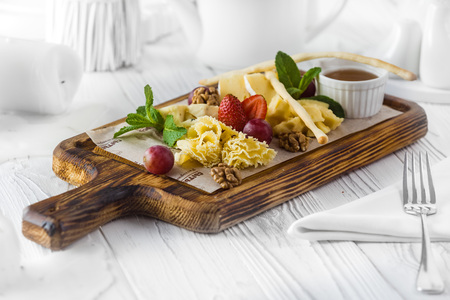 Nuts and strawberry as a dessert on a boardの写真素材