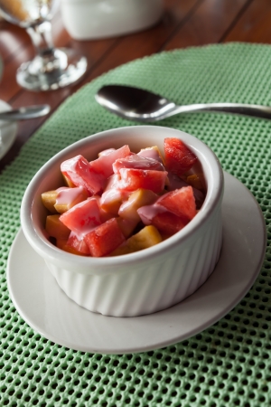 Breakfast of fresh watermelon, mango, apple and banana with a drizzle of strawberry yogurt on topの写真素材