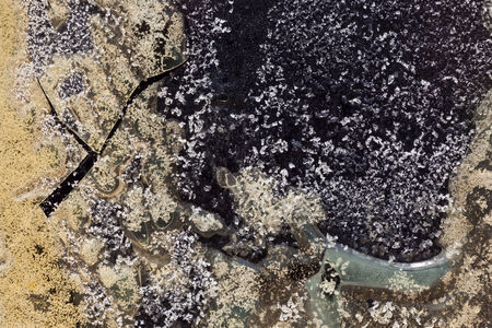 Texture of old crystallized and half melted glue on a commercial doorの写真素材
