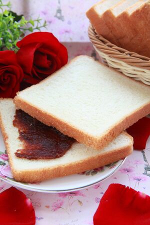 bread with red jamの写真素材