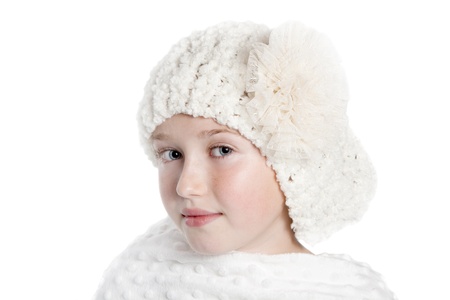 an attractive girl in a white winter hat and wearing a white shawl, she has blue eyes and is isolated on a white background.の写真素材