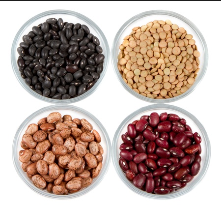 black beans, red beans, pinto beans and lentils photographed in round jars isolated on a white backgroundの写真素材