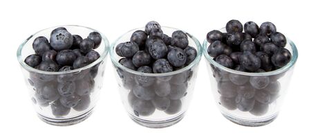 blueberries isolated on a white background in three glass jarsの写真素材