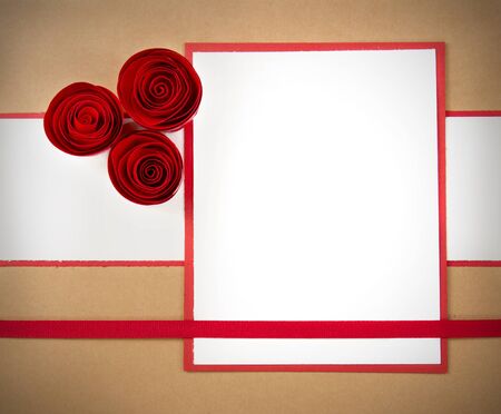 handmade paper rosesettes on a white and brown vintage looking paper background, with white copy spaceの写真素材
