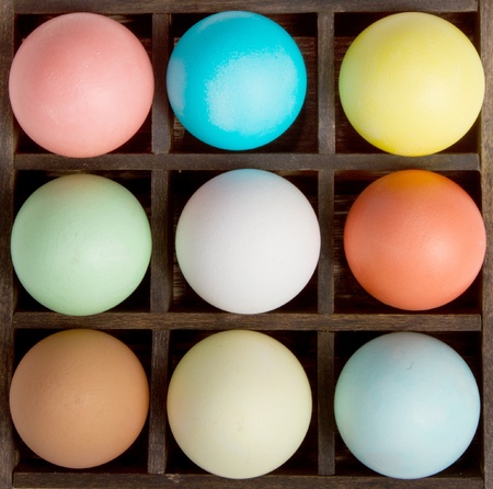 Nine pastel  easter eggs in a printers boxの写真素材