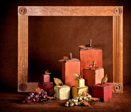Autumn still life in squares with a frame and brown textured background.の写真素材