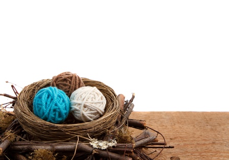Balls of yarn in a nest easter decoration, on a white isolated background, room for copyspace.の写真素材