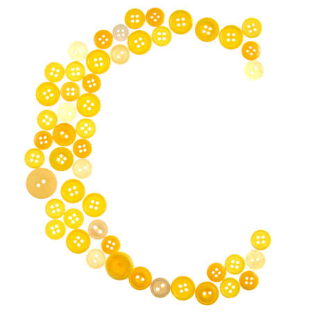 The letter C made of photographed buttons, isolated on a white backgroundの写真素材