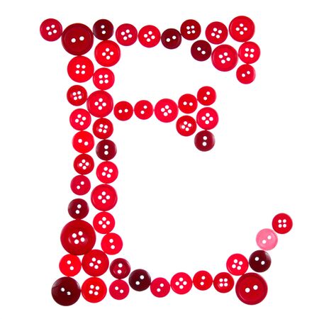 The letter E made of photographed buttons, isolated on a white backgroundの写真素材