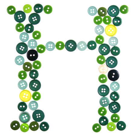 The letter H made of photographed buttons, isolated on a white backgroundの写真素材