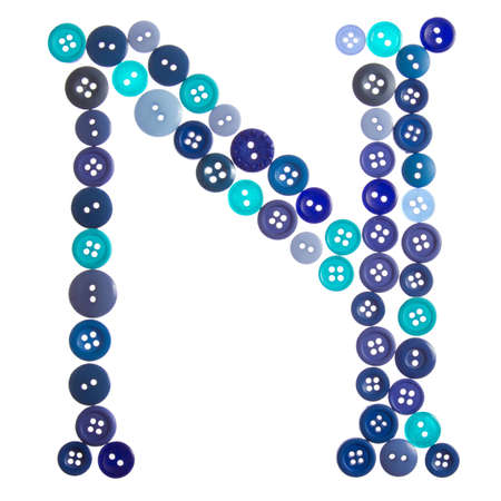 The letter N made of photographed buttons, isolated on a white backgroundの写真素材