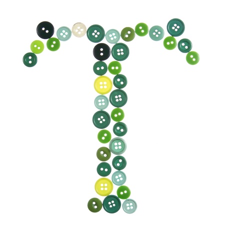 The letter T made of photographed buttons, isolated on a white backgroundの写真素材