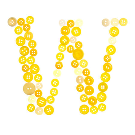 The letter W made of photographed buttons, isolated on a white backgroundの写真素材