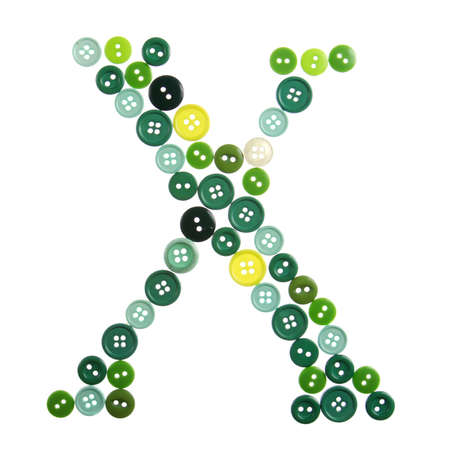 The letter X made of photographed buttons, isolated on a white backgroundの写真素材