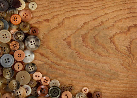 Assorted vintage sewing buttons on a wooded background, room for copy spaceの写真素材