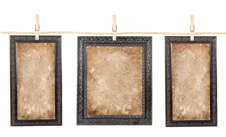 Three picture frames with aged paper isolated on a clothes lineの写真素材