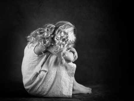 Sad little girl in black and whiteの写真素材