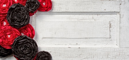 Black and Red shabby chic flowers on vintage doorの写真素材