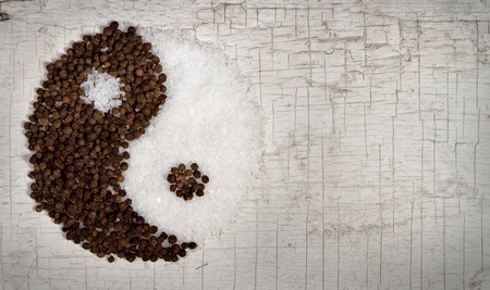 Yin and Yang salt and pepper on an old door for backgroundの写真素材