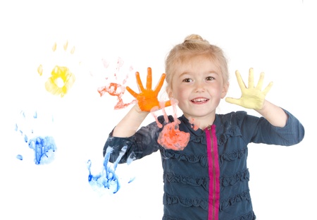 Little girl painting handprints on window, isolated on white backgroundの写真素材