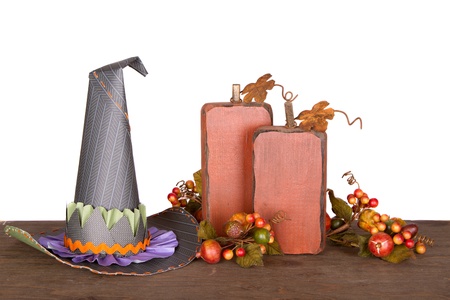 Witches hat and decorative pumkins isolated on a wooded plankの写真素材