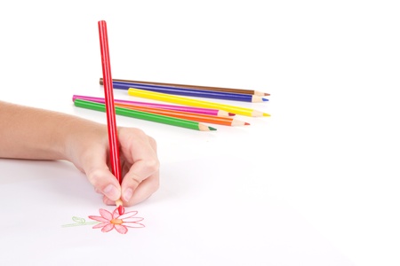 Close-up of girl drawing a flower with colored pencilsの写真素材