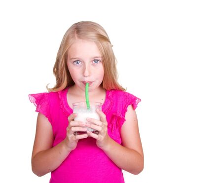 Girl drinking milk through a straw, isolated on whiteの写真素材