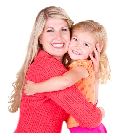 Mother hugging young daughter, isolated on whiteの写真素材