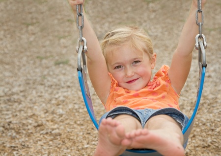 little girl or preschooler swinging on swing